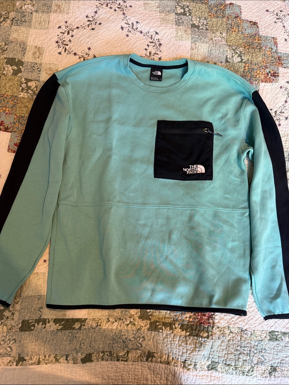 The North Face Men’s aqua blue performance Crewneck with Black Zip Pocket